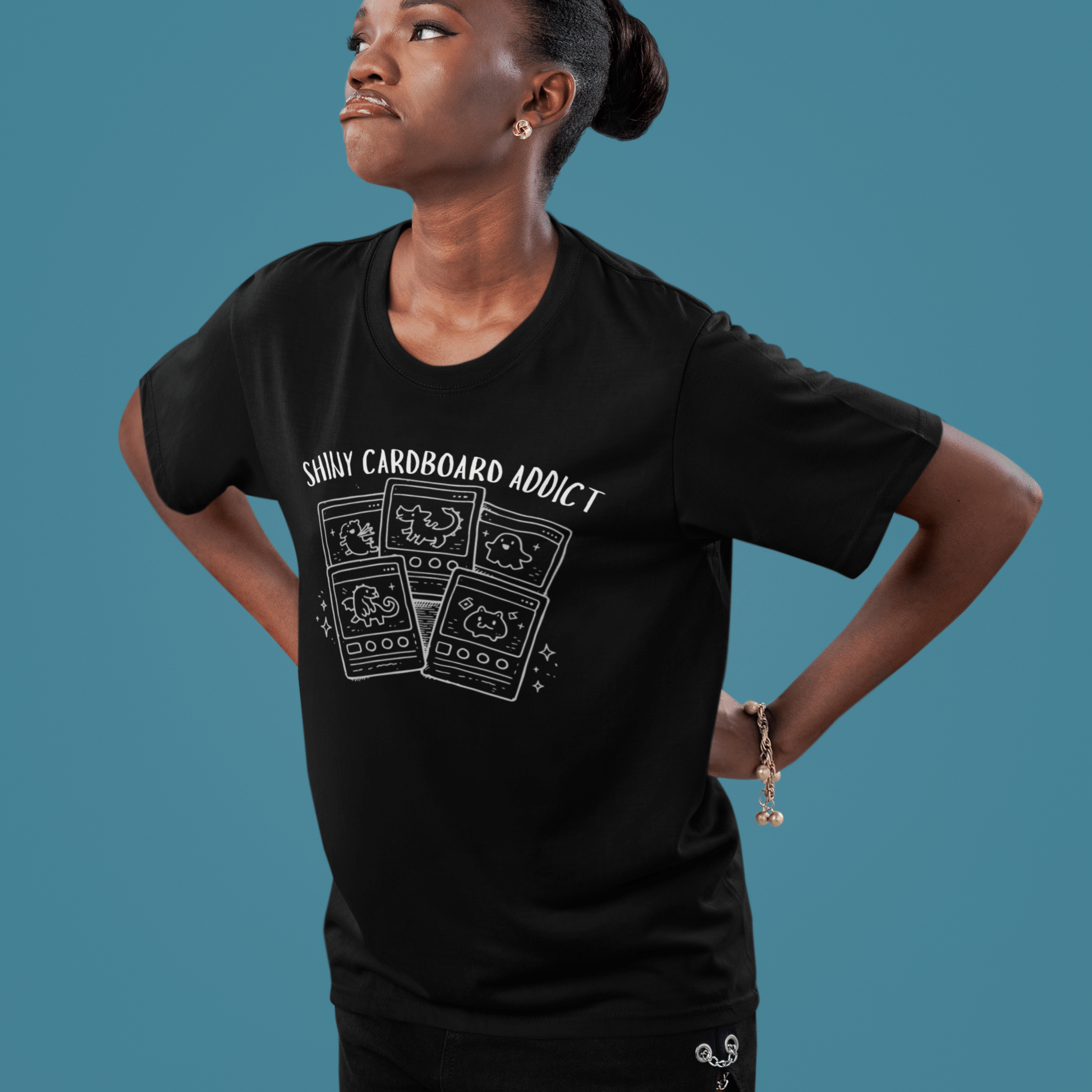 woman wearing funny pokemon tshirt with "shiny cardboard addict" and derpy TCG cards