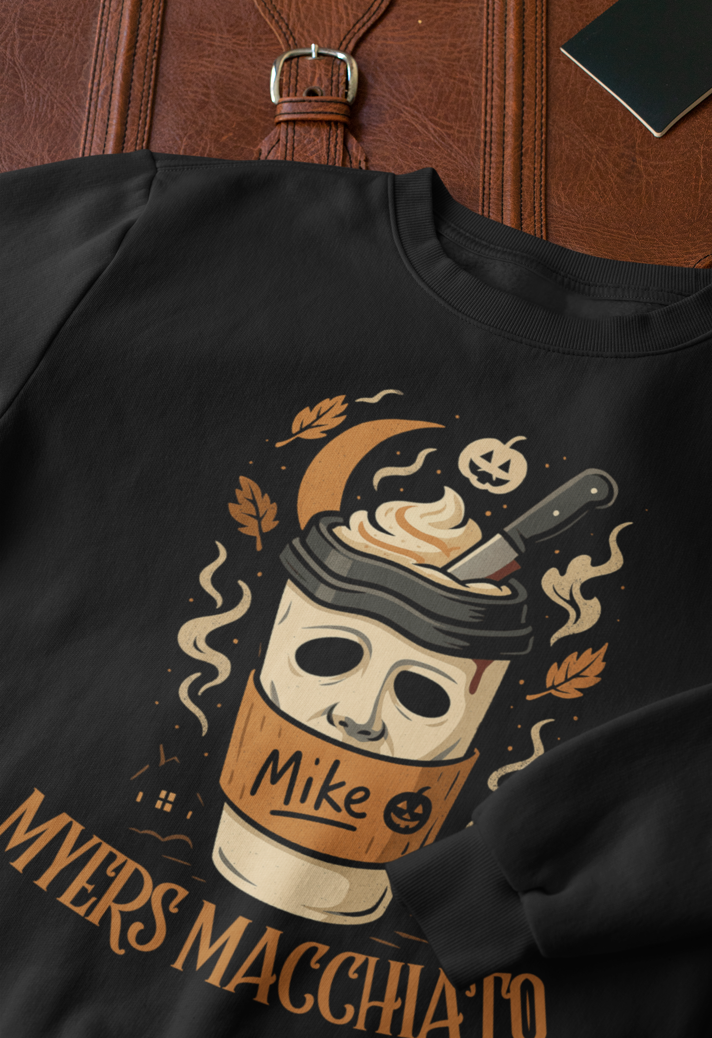 closeup-mockup-of-a-crewneck-sweatshirt-next-to-a-briefcase-33716.png