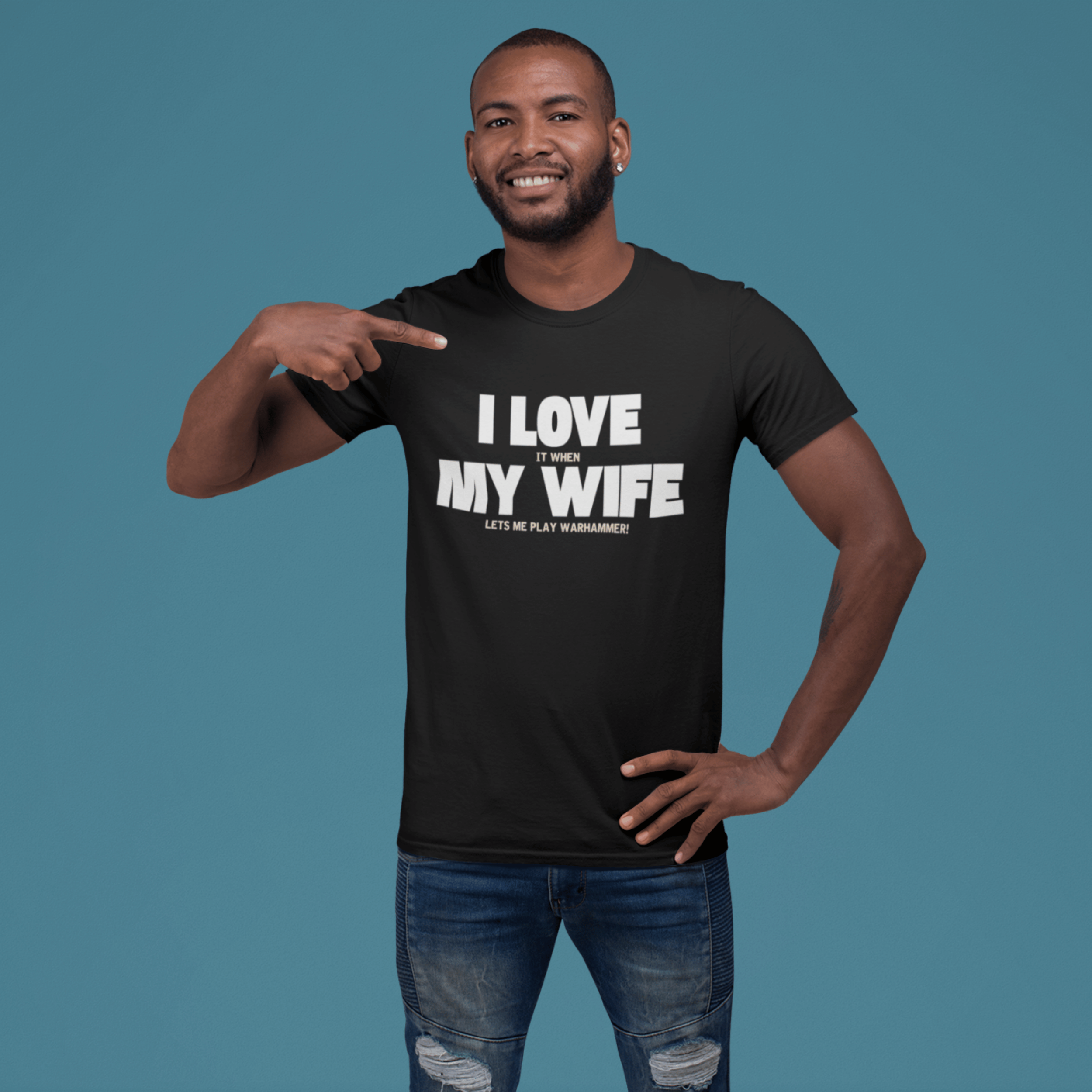 man wearing Funny Warhammer t-shirt for husbands with wording "I love it when my wife lets me play warhammer!"