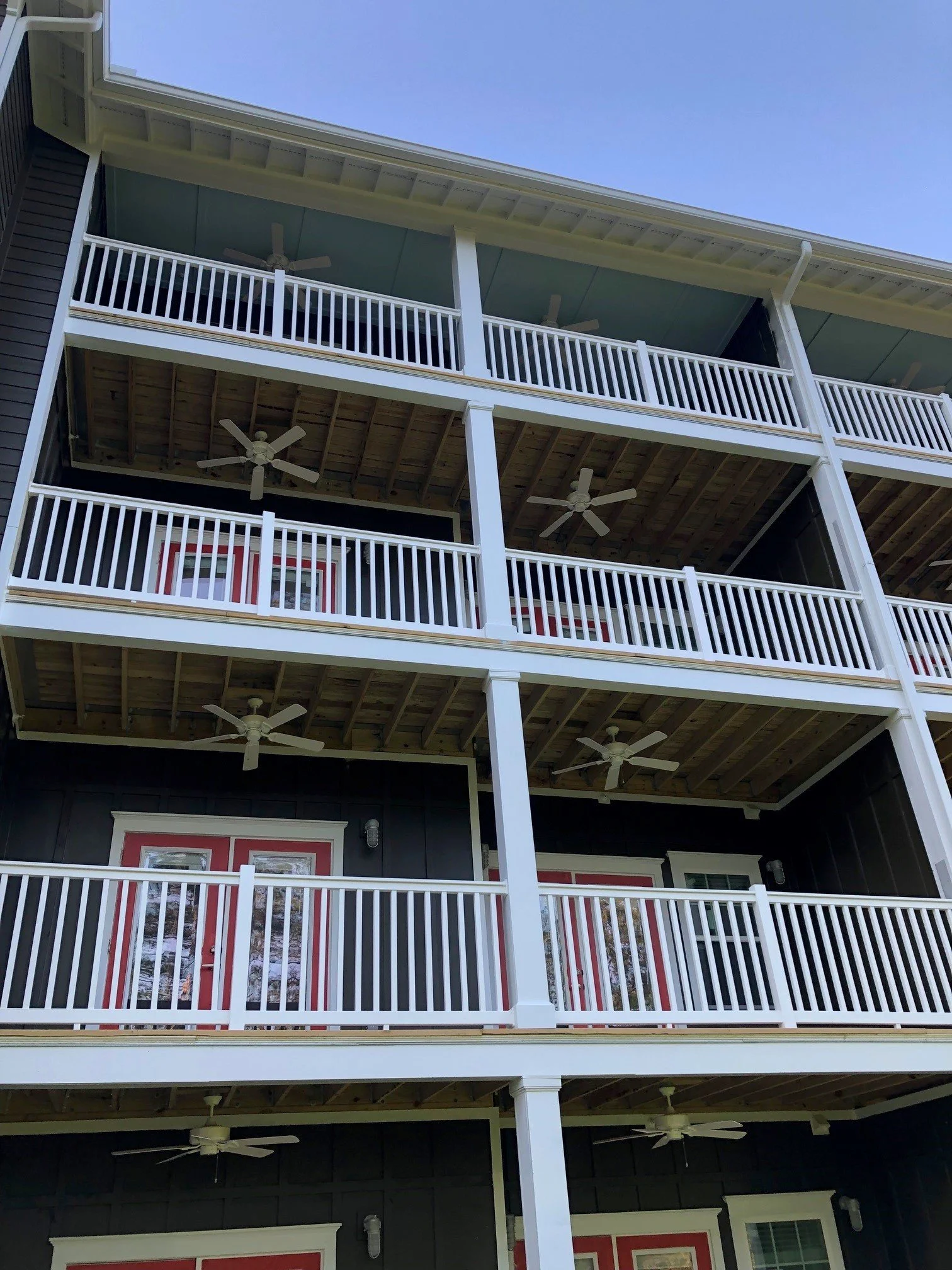 Low-angle photograph of the balconies in the Swallowtail Flats multifamily apartment complex - Columbus, GA
