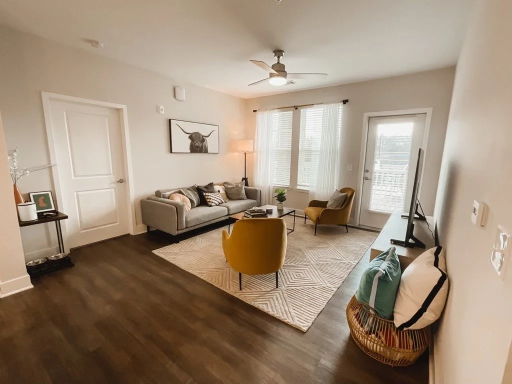 Wide-angle shot of a typical living room and a balcony within the Courtney Ridge multifamily apartment complex - Charlotte, NC
