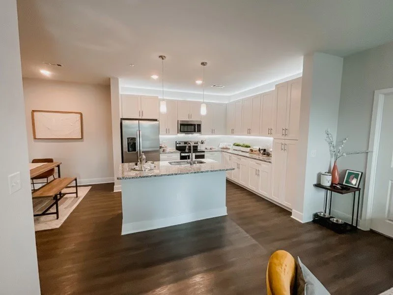 Courtney Ridge multifamily apartment complex typical kitchen and dining area with a small accent table and hardwood floors.
