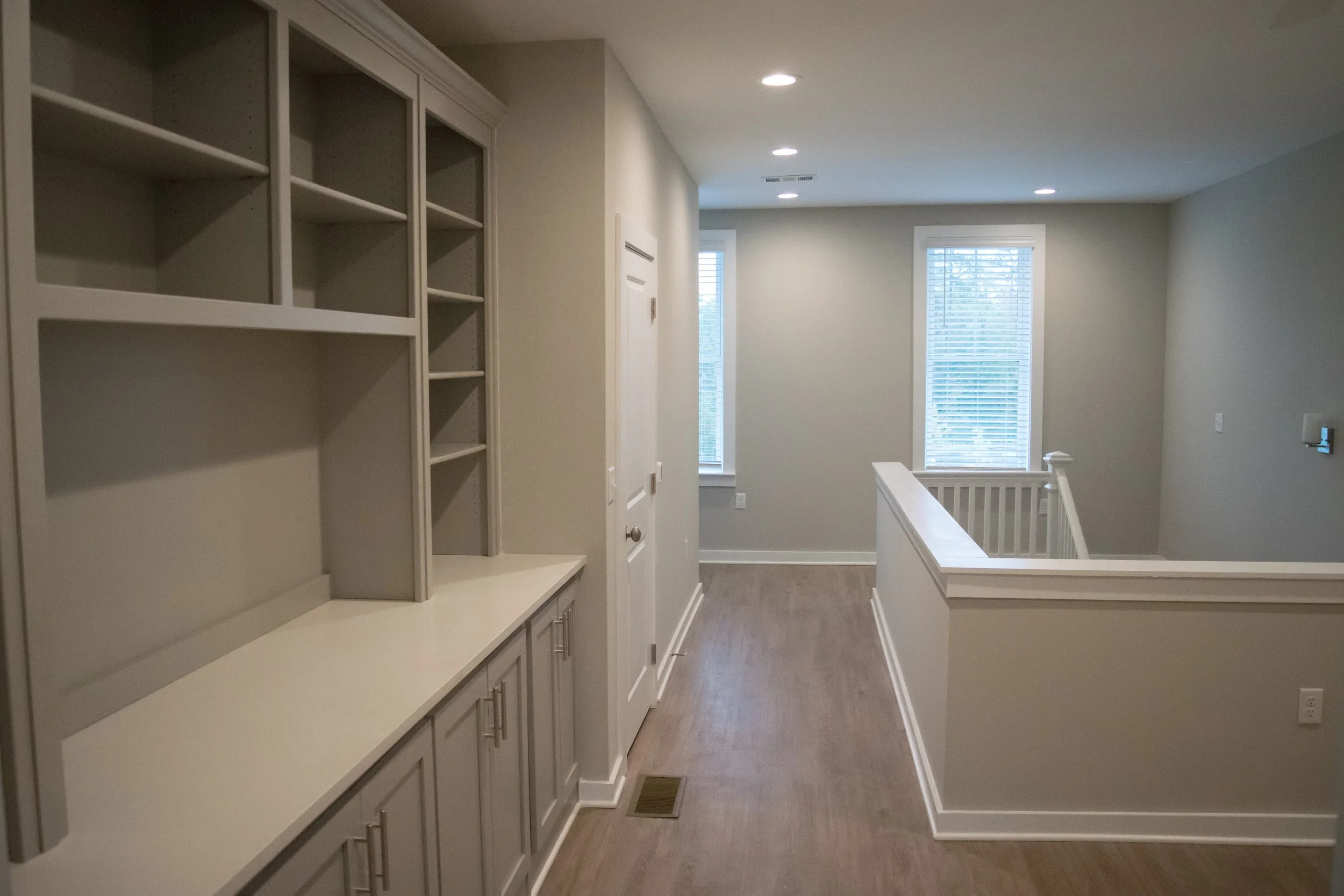 Typical upper stairway with storage, windows and wood floors in the Old Town Townhomes multifamily housing complex - Columbus, GA
