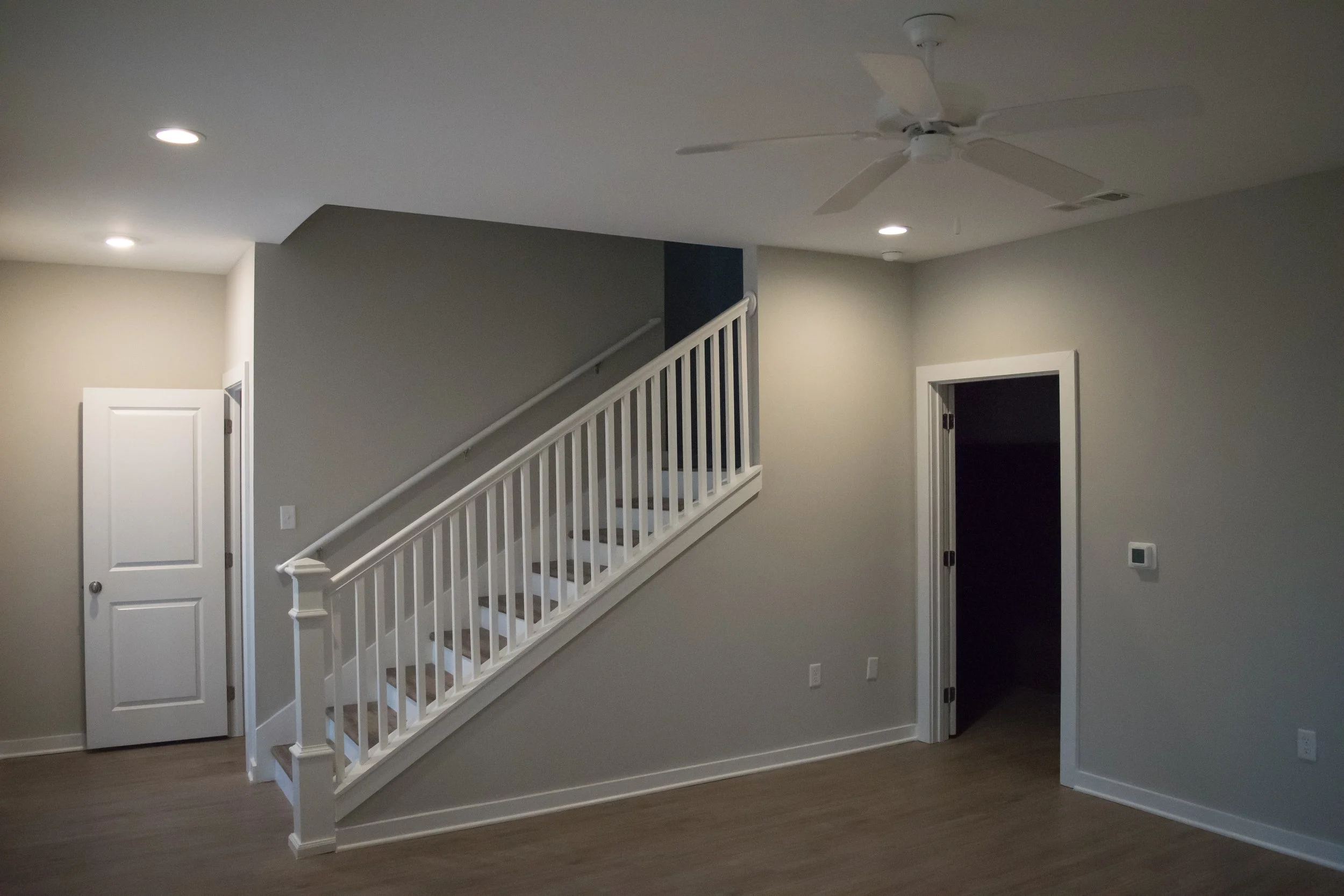 Living area and stairway in the Old Town Townhomes multifamily townhome complex - Columbus, GA