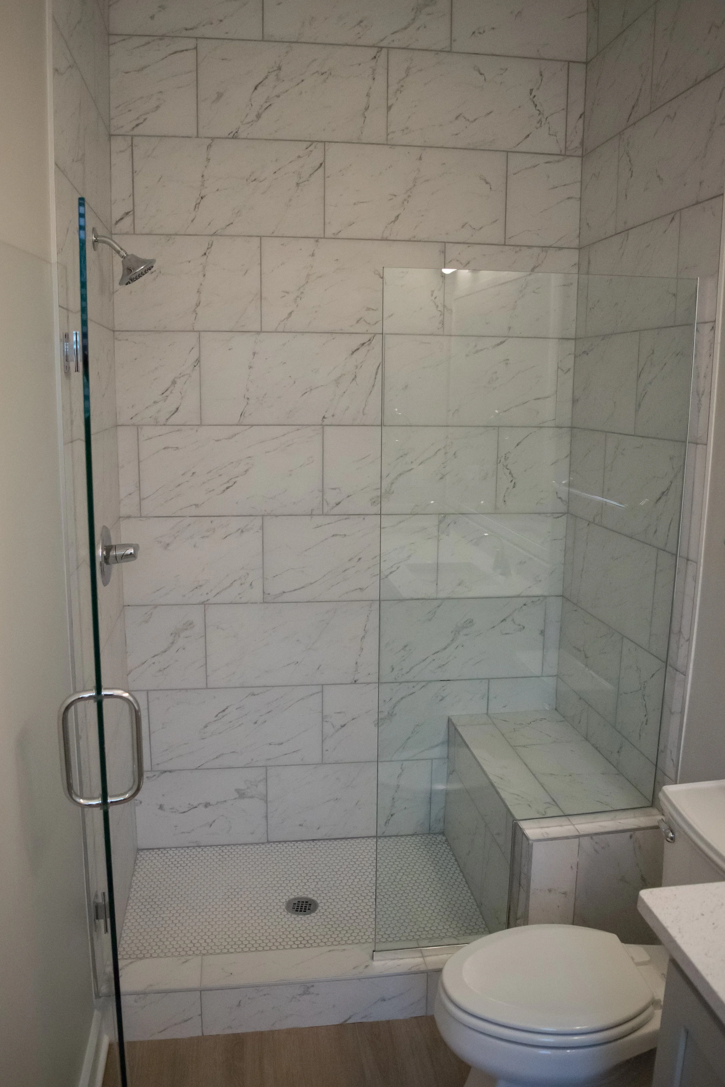 A typical bathroom with a walk-in shower and toilet in the multifamily townhome complex Old Town Townhomes - Columbus, GA