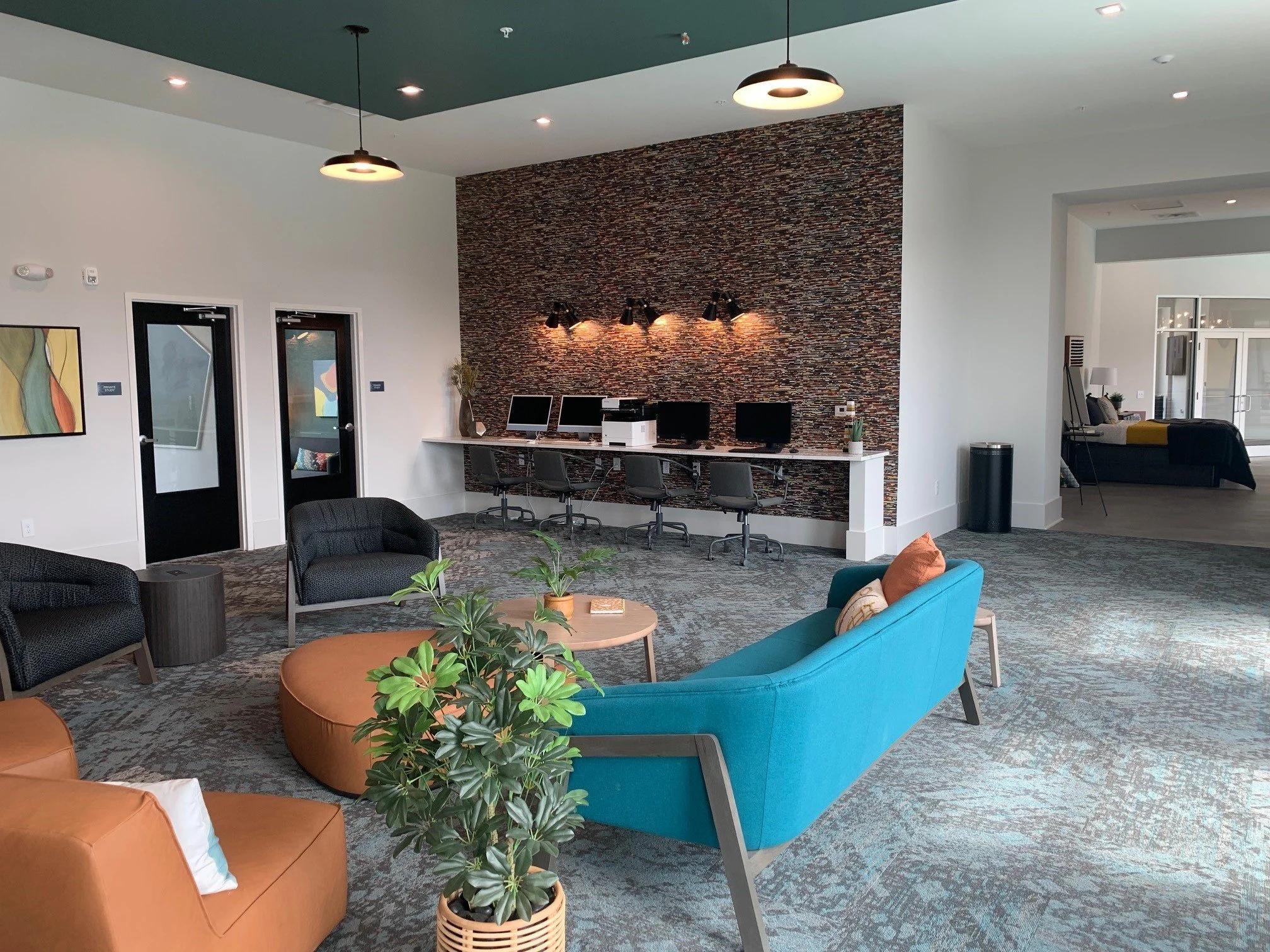 Business center and seating area located in the common room at The Beacon - Kennesaw, GA