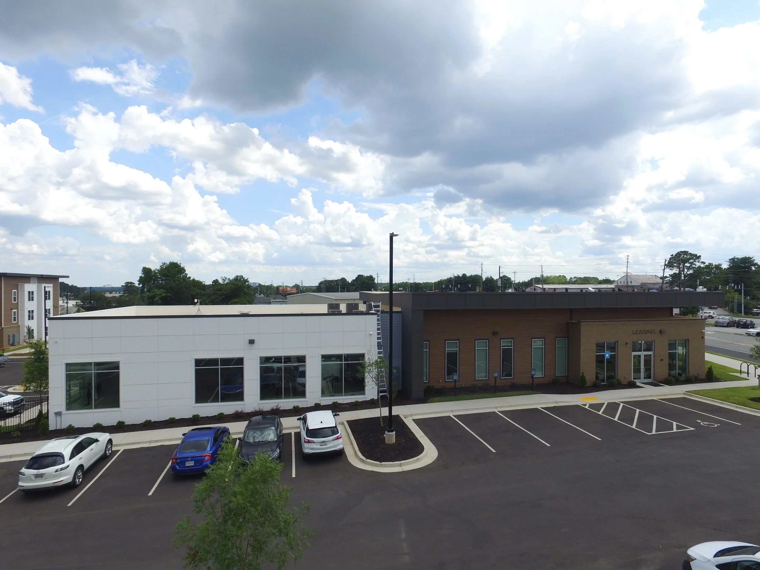 Overhead shot of the main office and the surrounding parking lot and trees at The Beacon - Kennesaw, GA