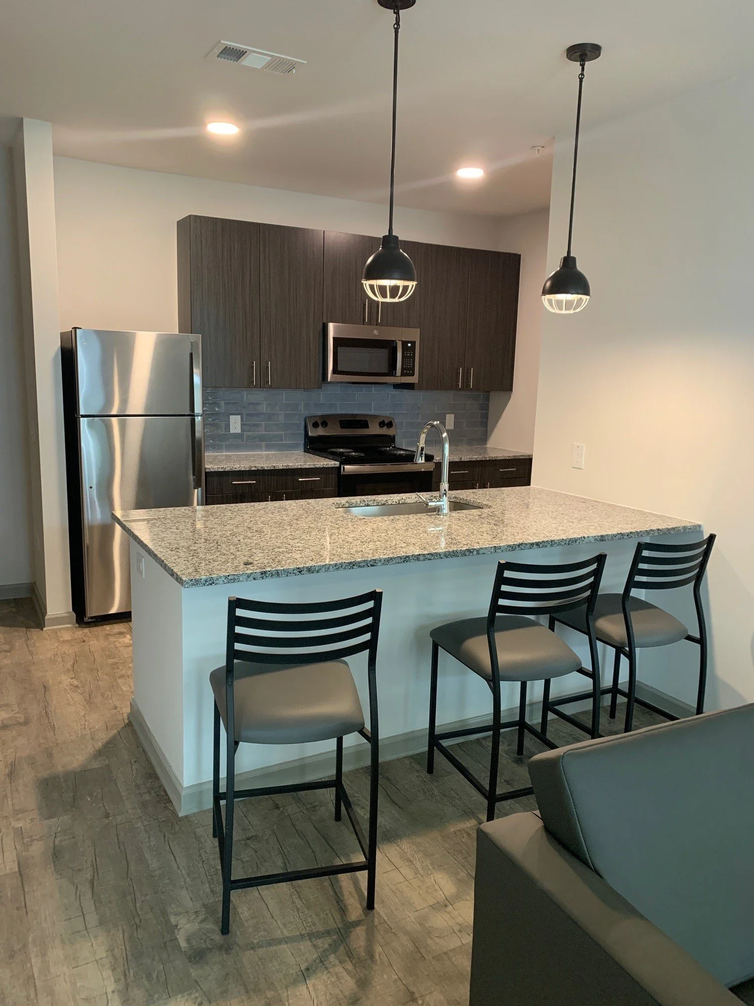 Kitchen and island bar in a typical unit at The Beacon - Kennesaw, GA
