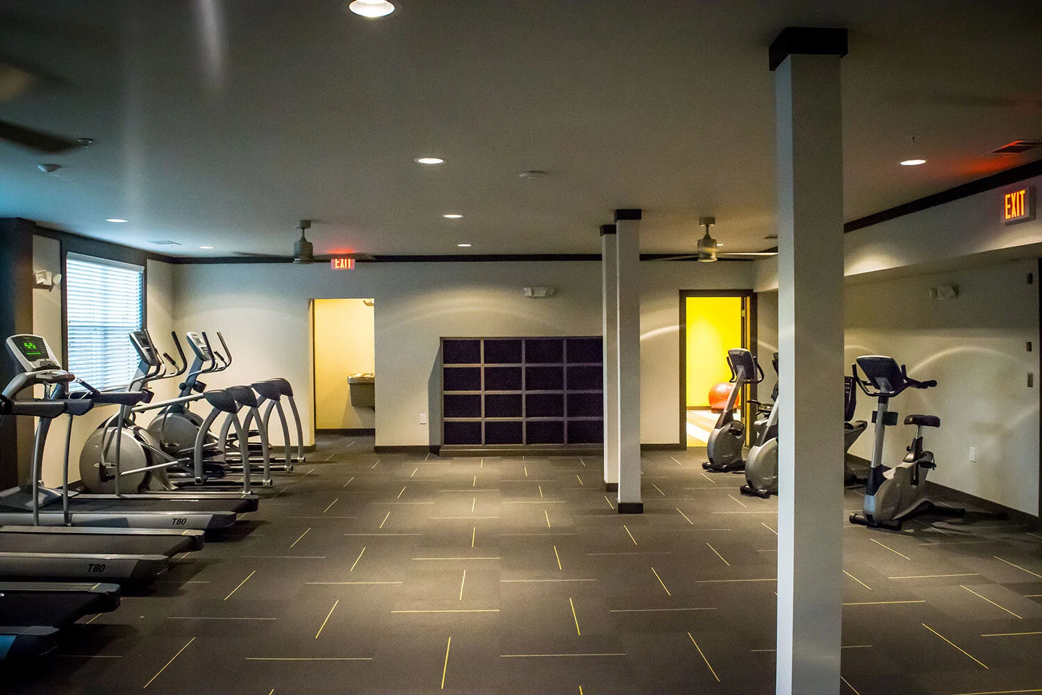 Fitness center with a few cardio machines and a storage shelf at the Riverpoint - Rome, GA