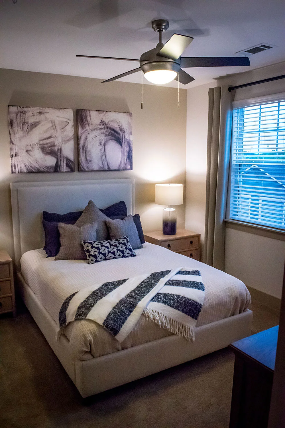 Typical bedroom with a black-and-white decoration theme, wall art, and a large window seen at Riverpoint - Rome, GA