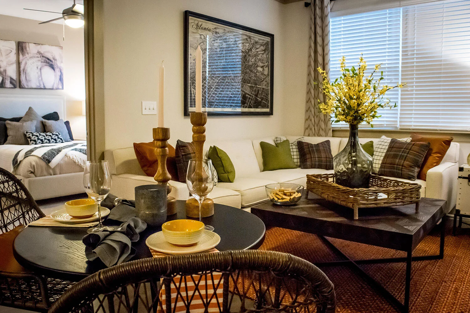 Living room with table, chairs and a large couch in the background seen at Riverpoint - Rome, GA