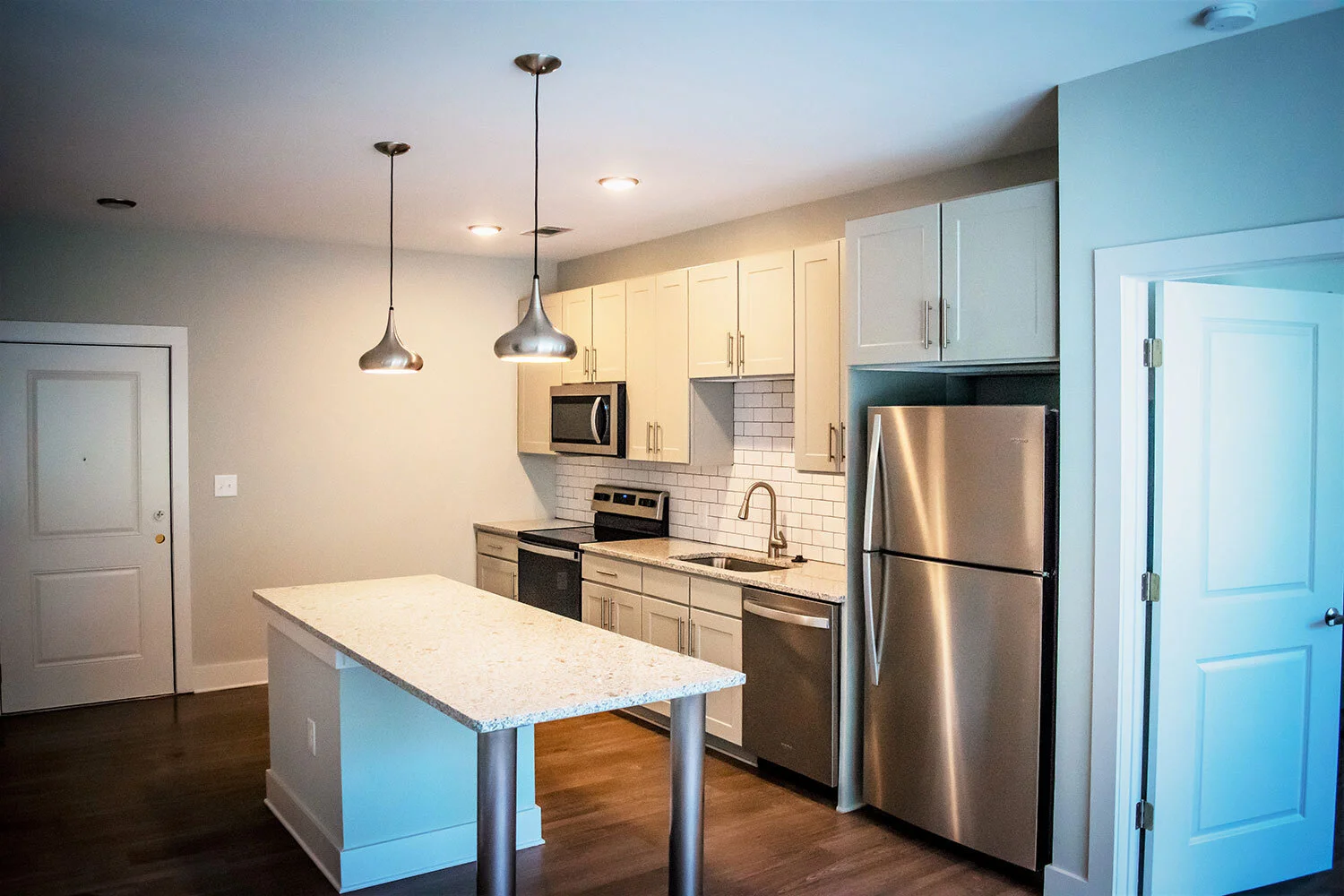 Kitchen, various appliances, and prep station in a typical multifamily complex unit at City of Refuge - Atlanta, GA