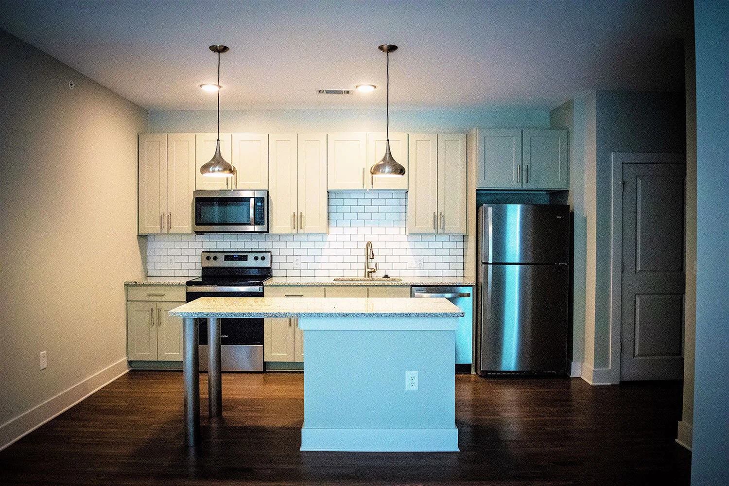 Kitchen, various appliances, and prep station in a typical multifamily complex unit at City of Refuge - Atlanta, GA