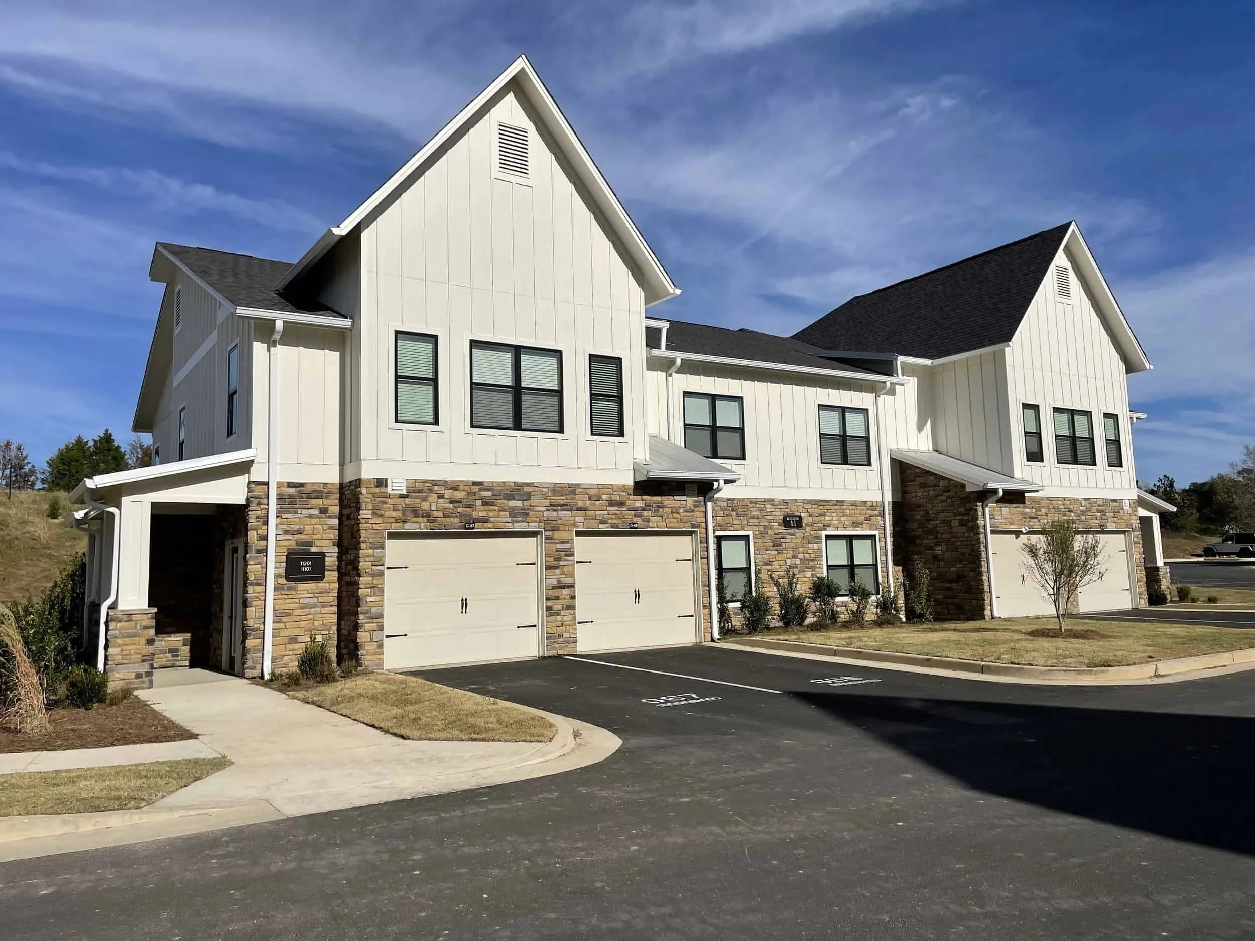Multifamily facade with roll-up garage doors.