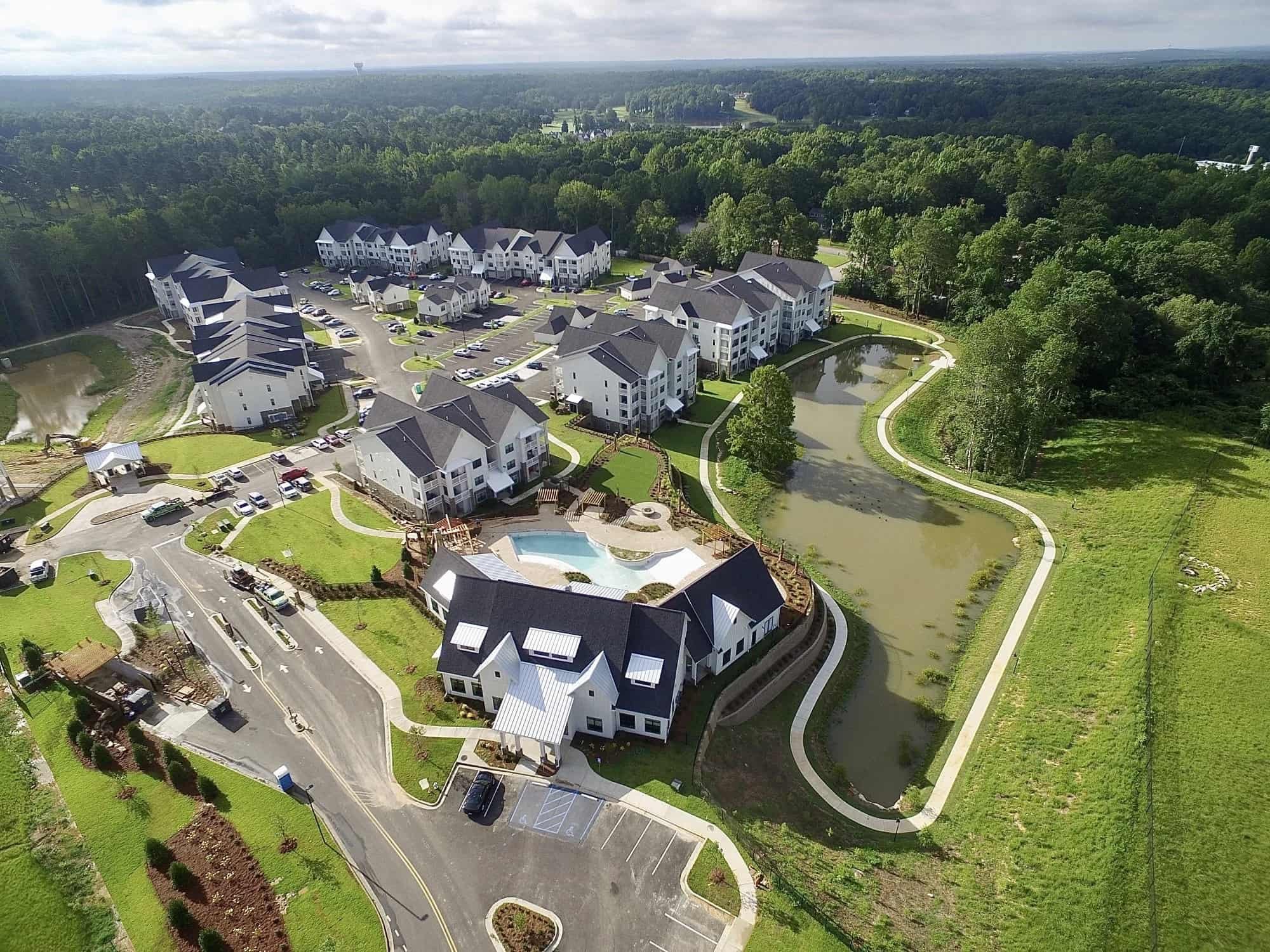 Aerial view of buildings, greenery, and streets.