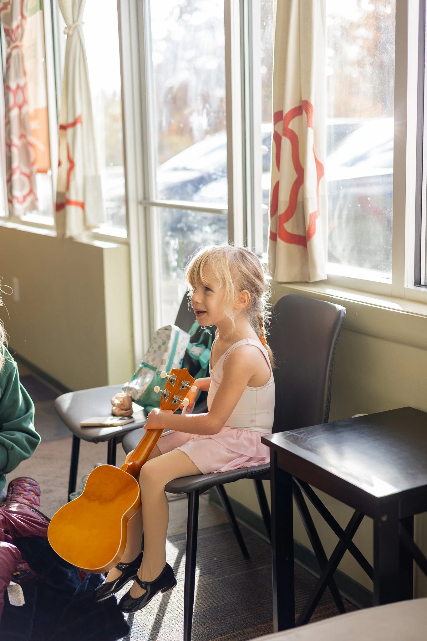 young girl waiting for ukulele lesson