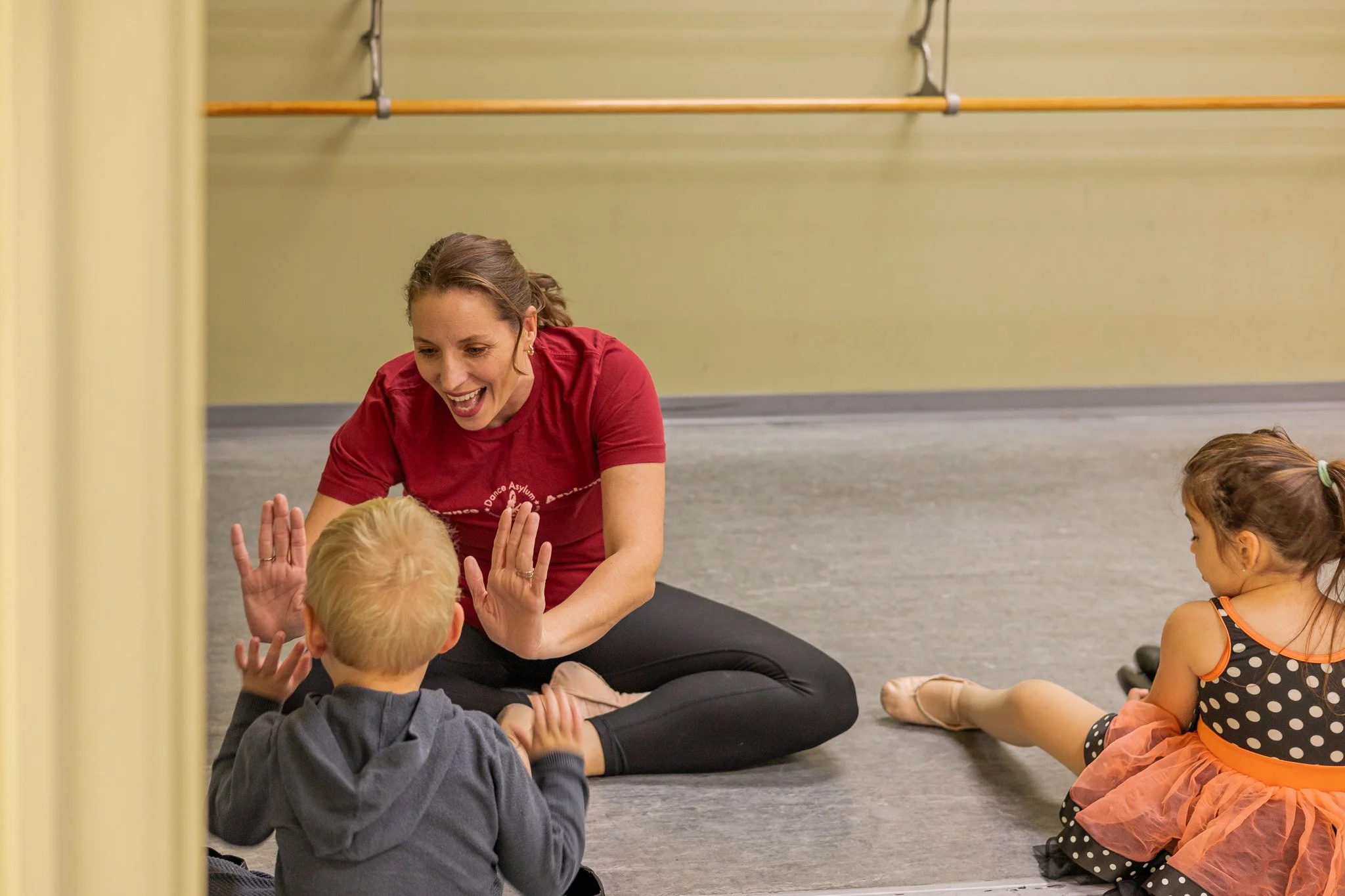 dance instructor high-fiving young student