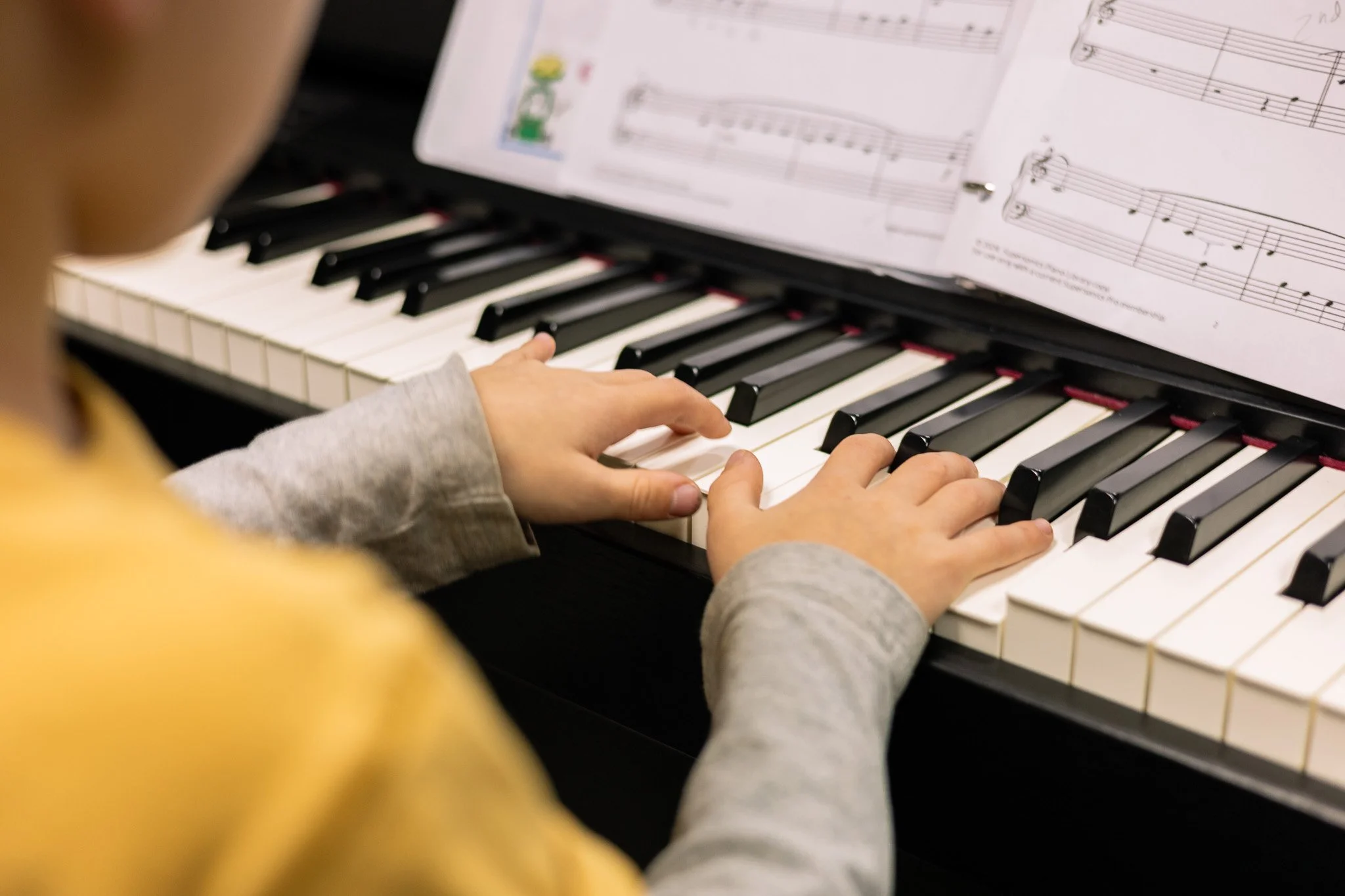 child practicing piano