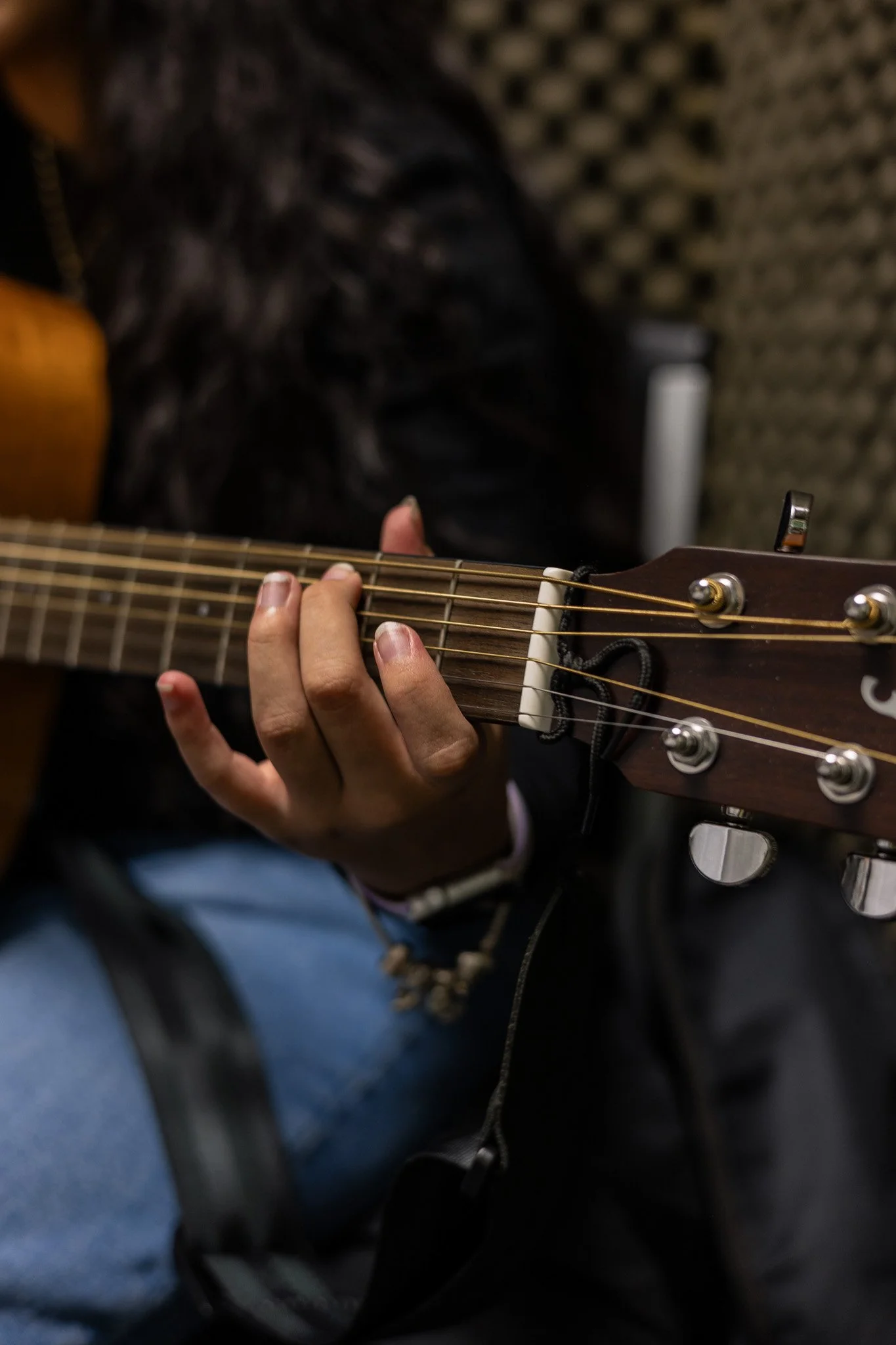 close-up view of hand on guitar