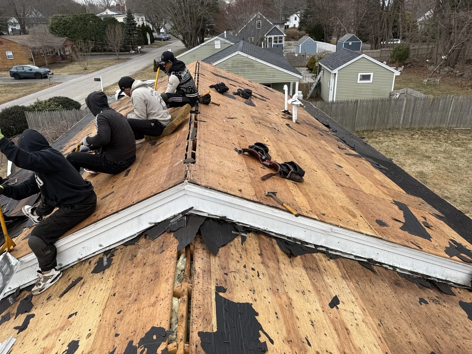 King Construction crew preparing a residential roof deck for new shingles.