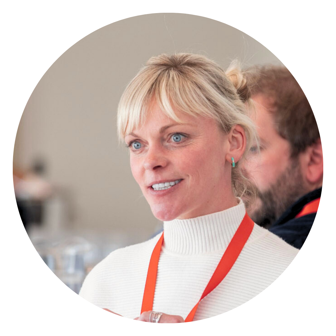 Lucy Winward, Commercial Manager at New Hall Wine Estate. Pictured speaking in a professional conference setting, with other people blurred in the background.