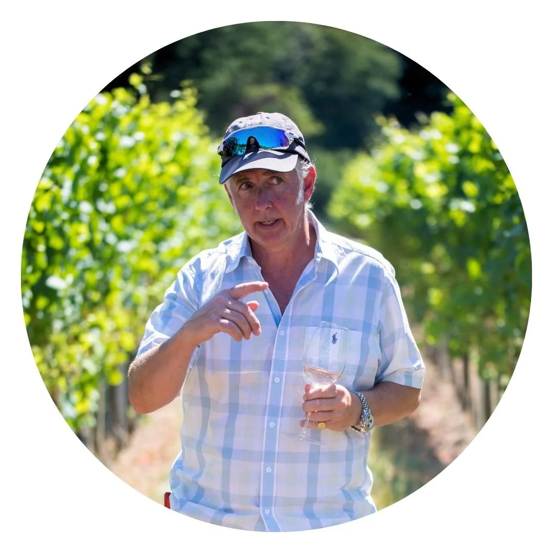 Charlie Scrase-Dickins, co-owner of Coolhurst Vineyards, West Sussex, UK. A woman wearing a baseball cap and sunglasses holding a glass of rosé wine, standing in a vineyard on a sunny day.