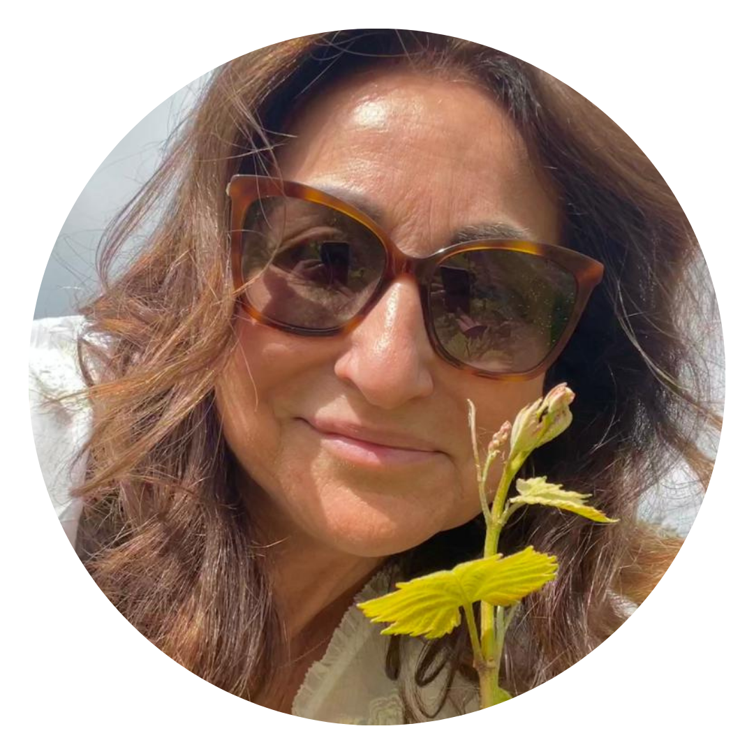 Susanna Jacobsohn, co-owner of Busi Jacobsohn Wine Estate, a vineyard in East Sussex, UK. Seen in a vineyard setting holding a vine shoot. 