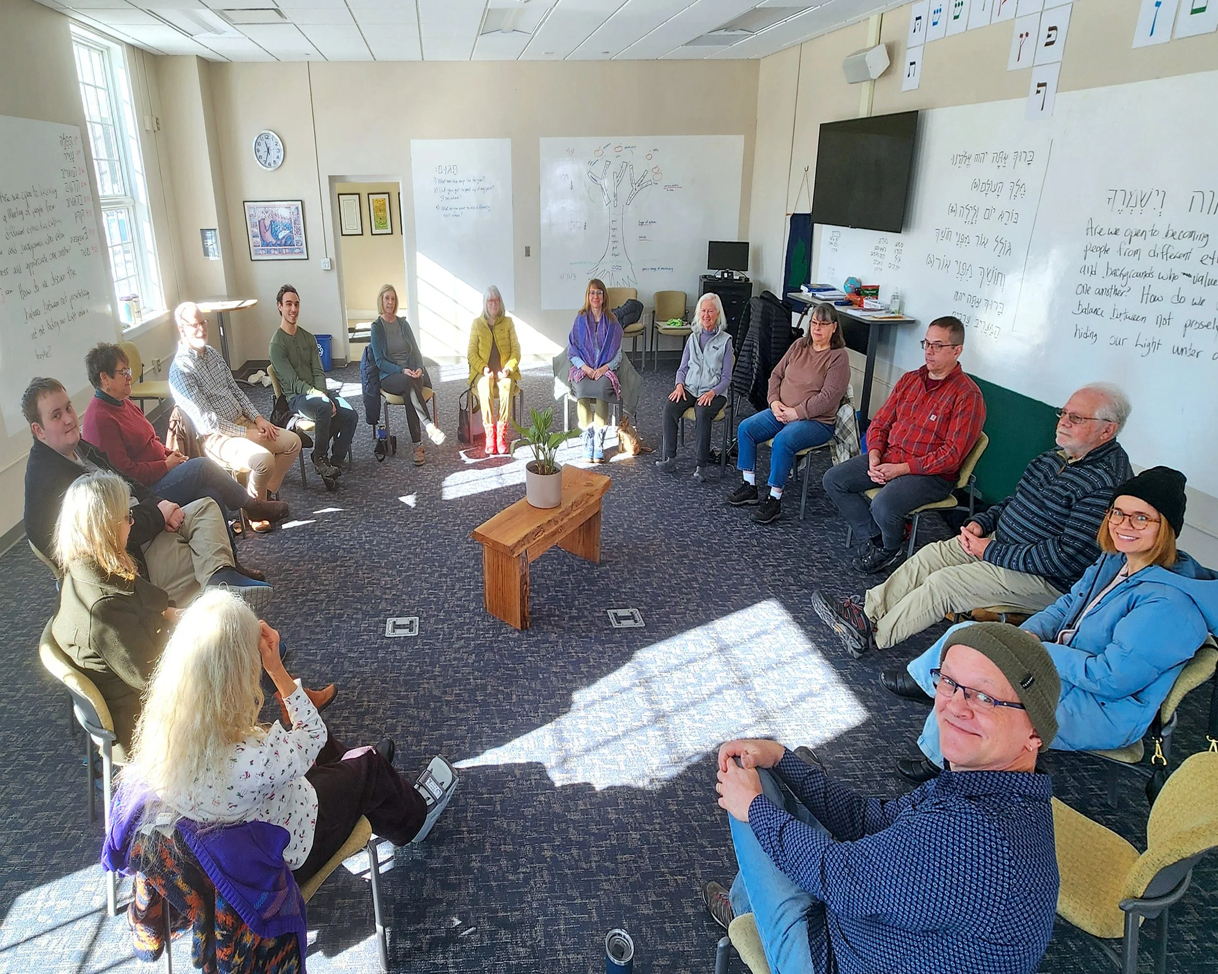 Members of Holland Friends Meeting gathered in a circle for unprogrammed Quaker worship, sharing silence and reflection together.