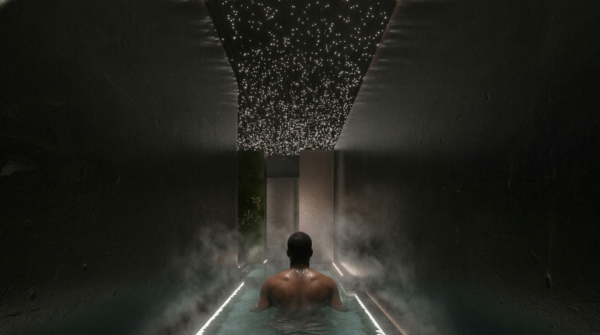 A man with a shaved head is sitting in a steam room or spa, facing away from the camera. The room has dark textured walls and a ceiling with small, bright star-like lights. There is steam rising from the water, creating a misty atmosphere.
