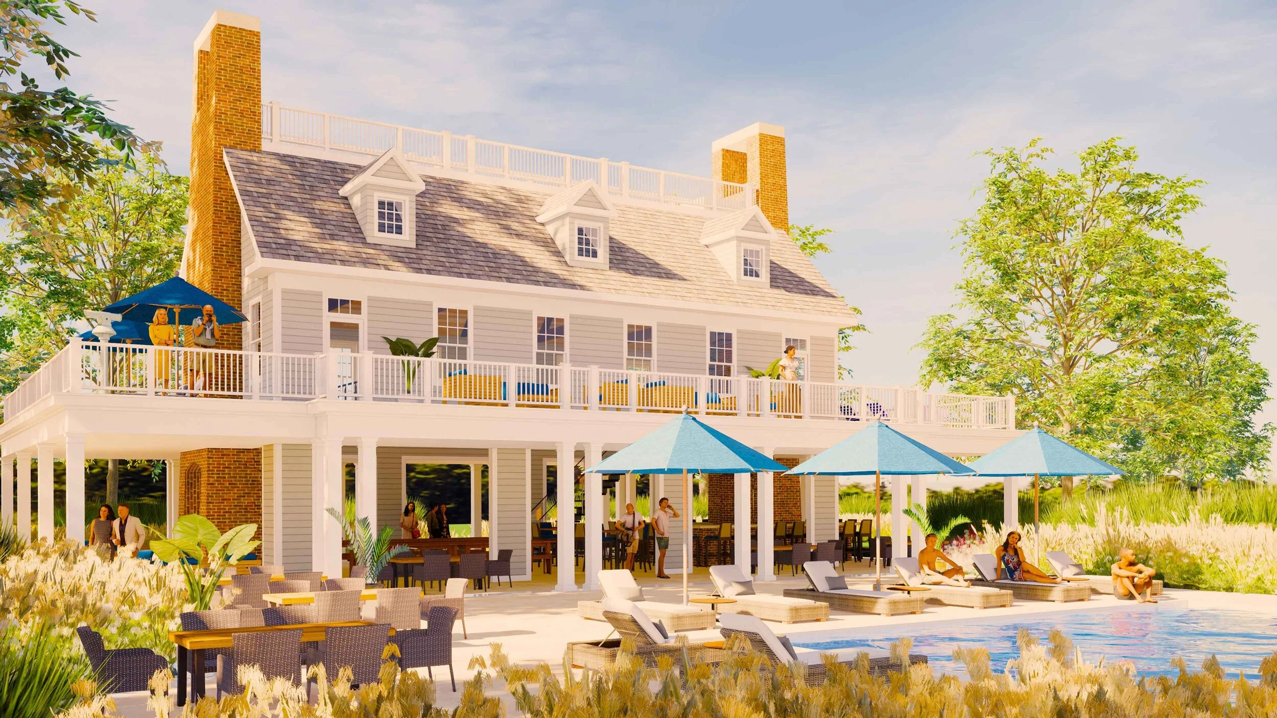 A large, white, multi-story house with a wraparound porch, surrounded by trees and grass. There are people on the porch and sitting by the pool, with blue umbrellas providing shade. The house has a peaked roof with dormer windows and several chimneys.