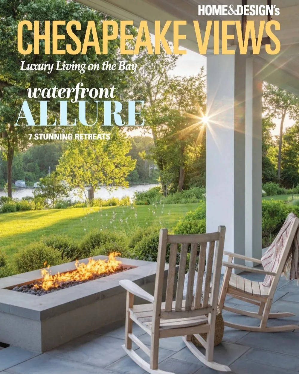 Kimmel Studio Architects Home & Design magazine featuring Chesapeake Views with waterfront allure, showing a view from a porch with a fire pit, rocking chairs, lush green lawn, and trees by a bay at sunset.