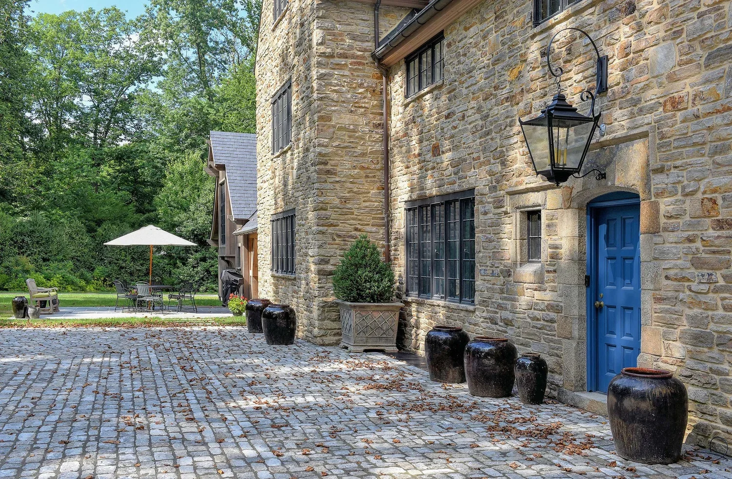 tudor-renovation-stone-historic-architecture-blue-door-entrance-pikesville-md-kimmel-architects.webp