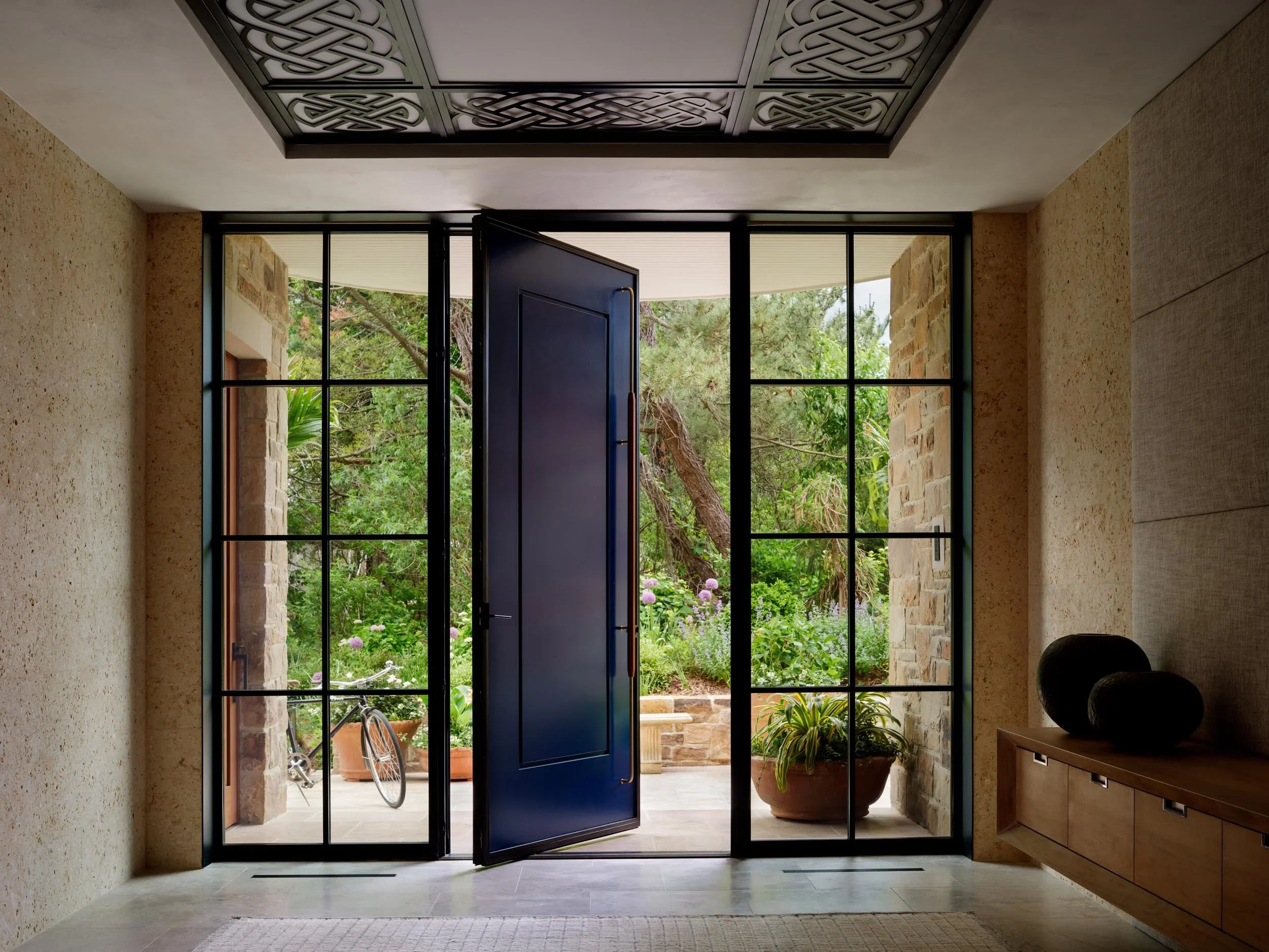 shingle-beach-house-coastal-blue-pivot-door-entryway-rehoboth-de-kimmel-architects.webp