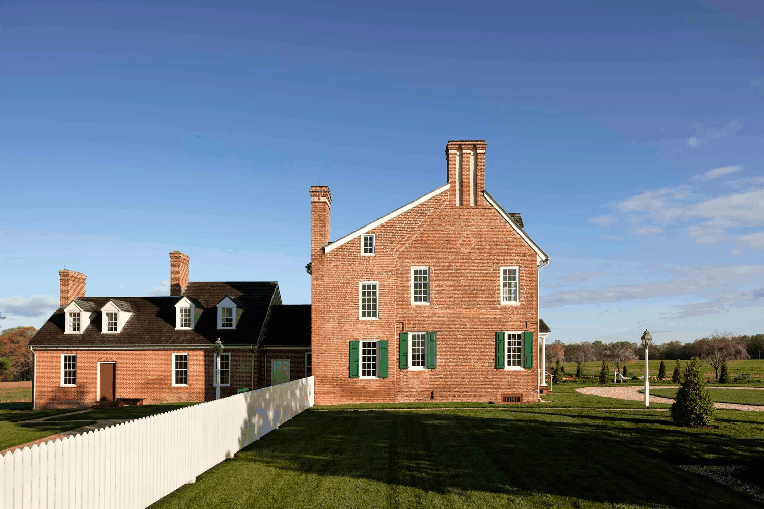 historic-house-renovation-side-facade-white-fence-queenstown-md-kimmel-architects.png