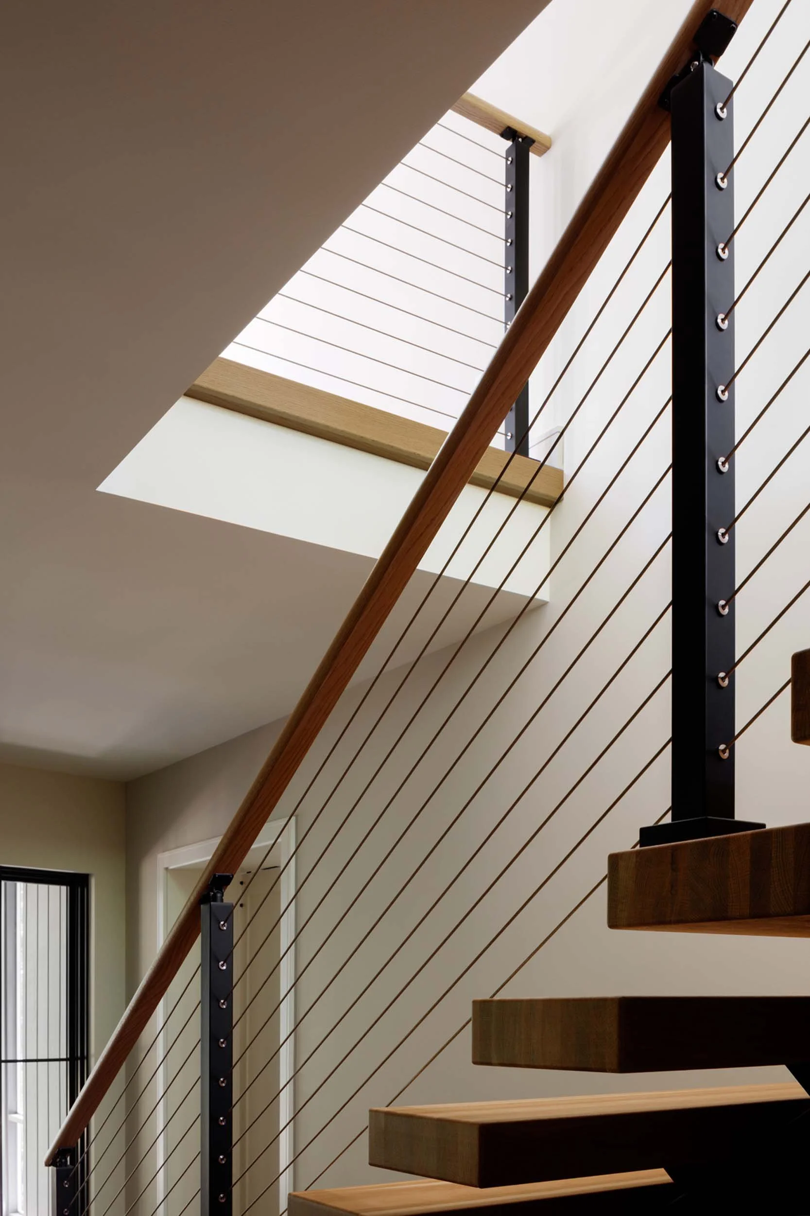 woodland-getaway-modern-floating-staircase-steel-railing-annapolis-md-kimmel-architects.jpg