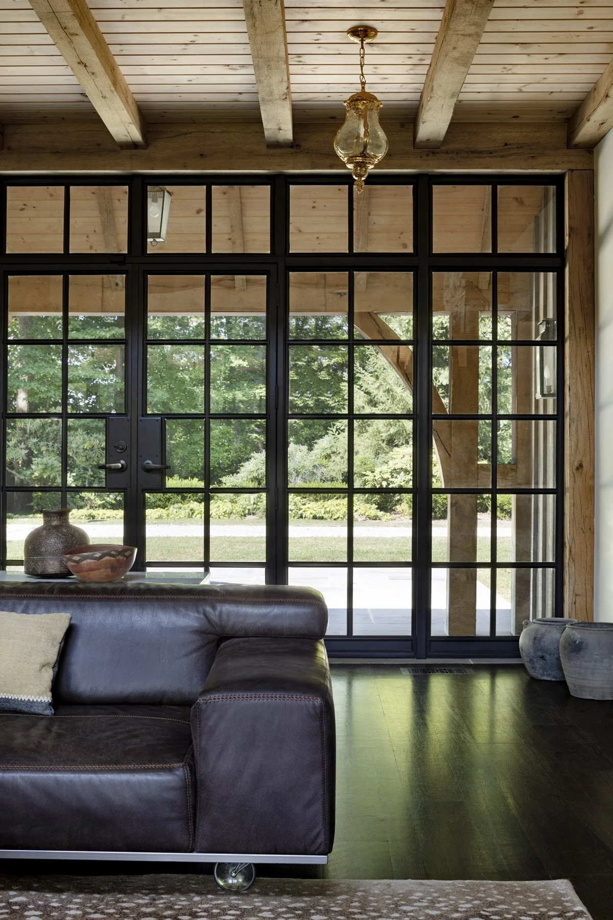 tudor-renovation-stone-living-room-steel-doors-pikesville-md-kimmel-architects.jpg