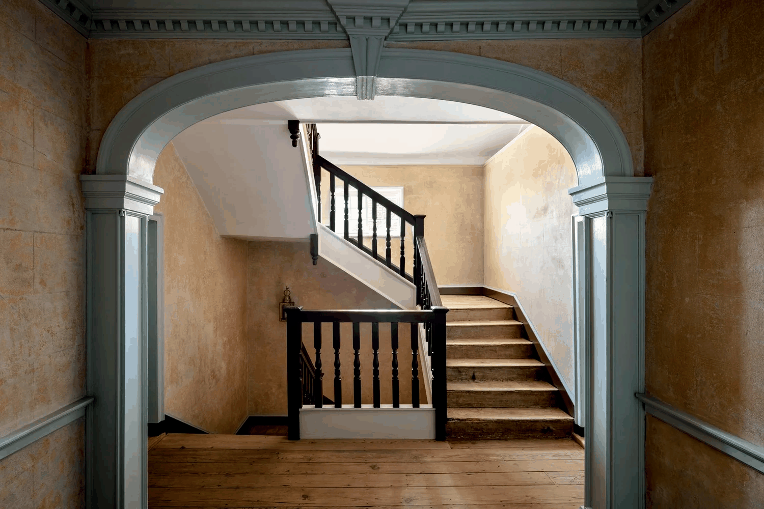 historic-house-renovation-hallway-archway-staircase-queenstown-md-kimmel-architects.png