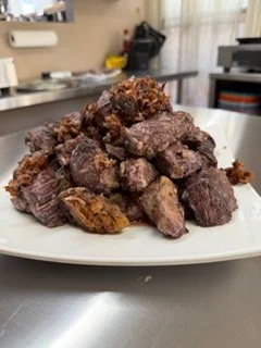 Flour-coated beef slowly seared until deeply browned, the foundation of traditional French La Daube at La Crêperie in Granbury.
