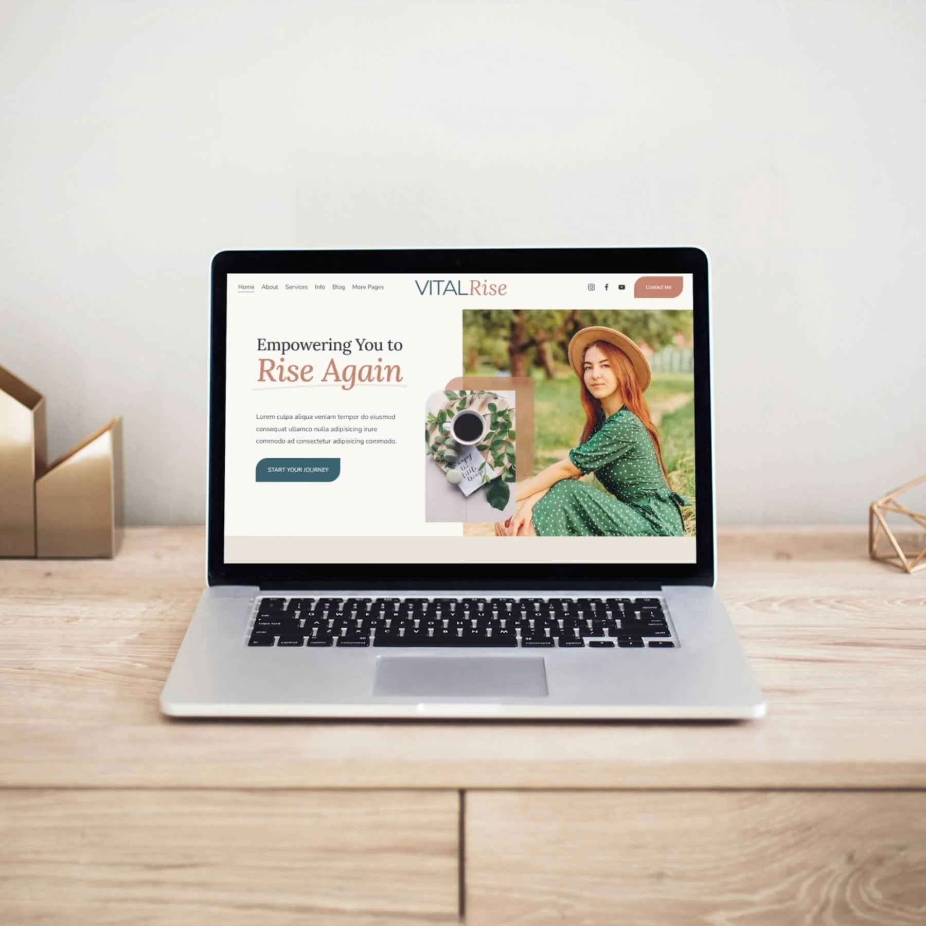 Laptop on wooden desk displaying a website template titled VITAL Rise with a woman in a green polka dot dress and hat, sitting outdoors.
