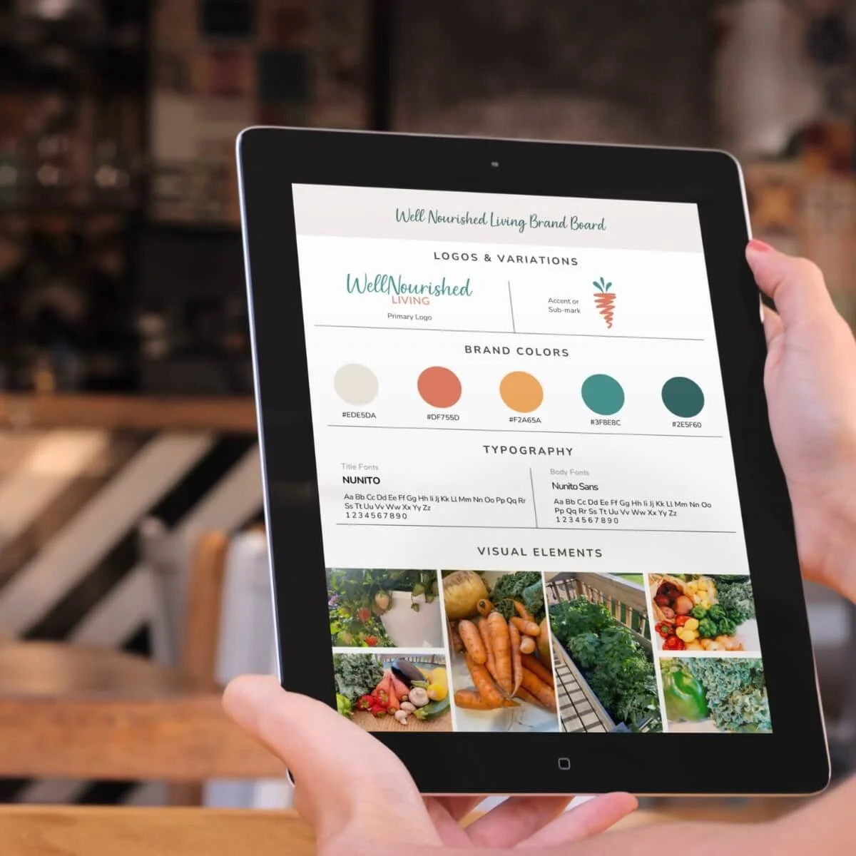Close-up of a tablet screen displaying a brand board with logos, color palette, typography, and visual elements for 'Well Nourished Living.'