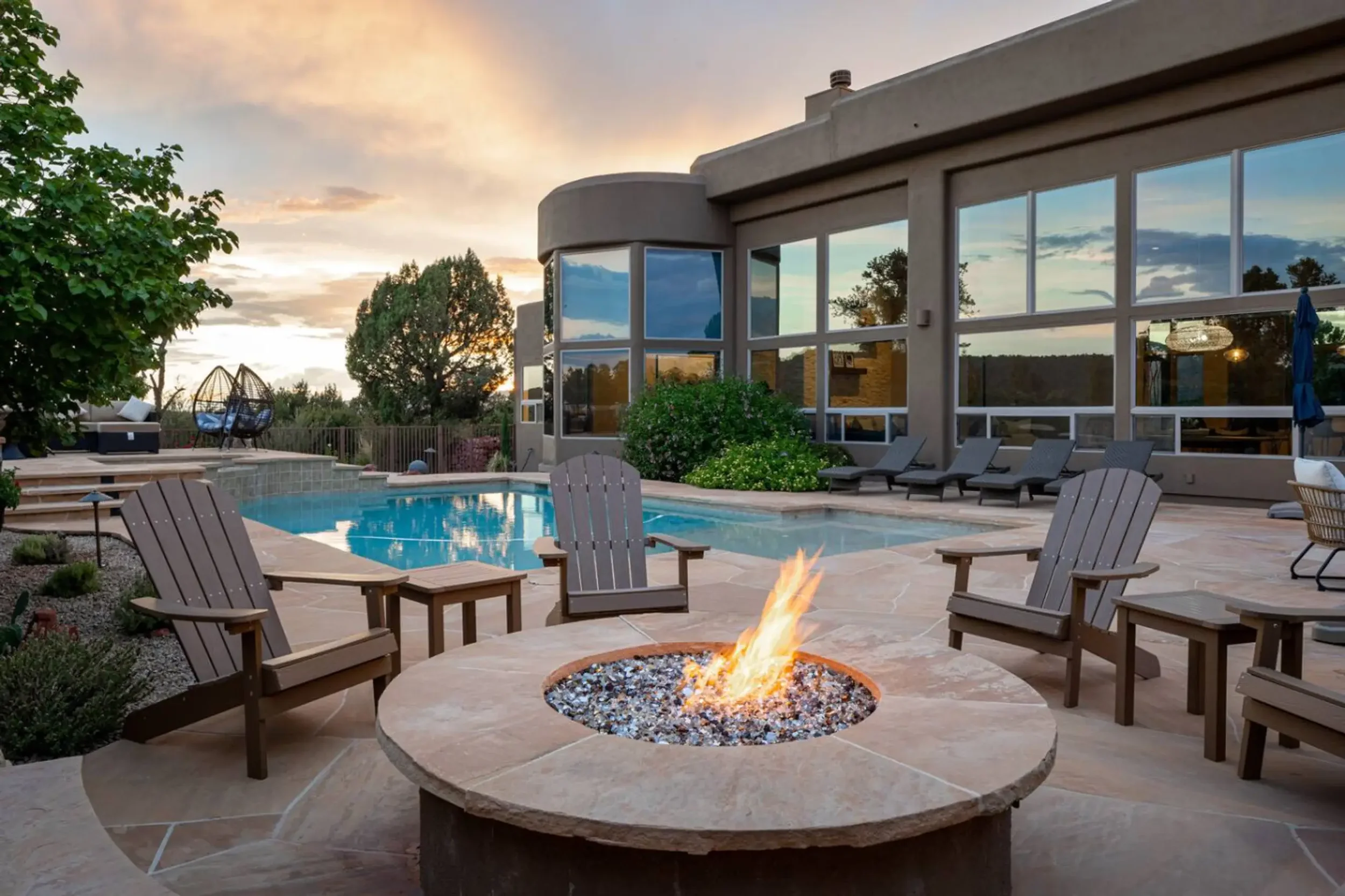 Backyard pool with large home and firepit