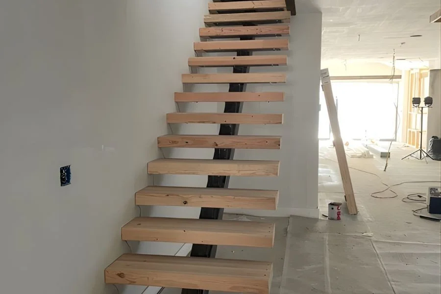 Designer iron staircase with wire railings in a modern living room.