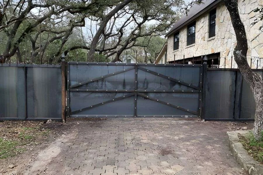 Modern steel driveway gate with solid privacy panels
