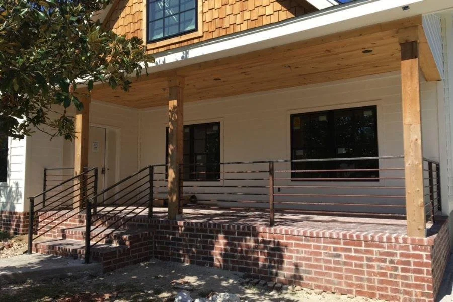 Horizontal metal railing installed on front porch