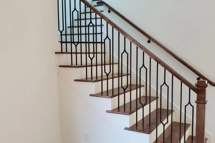 Custom black iron railing with wooden handrail