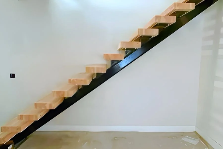Side view of wooden steps on a black diagonal metal beam