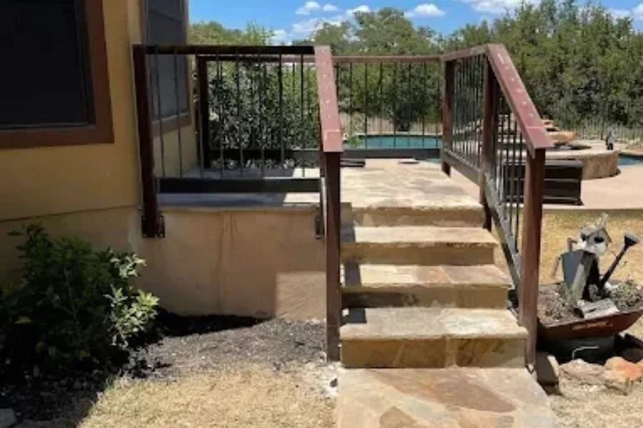 Outdoor metal railing installed on stone steps