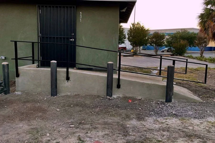 Metal ramp railing installed outside commercial building
