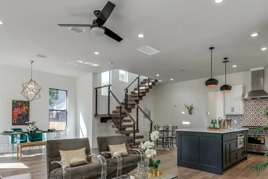 Overview of a modern open-plan house featuring a matel staircase.