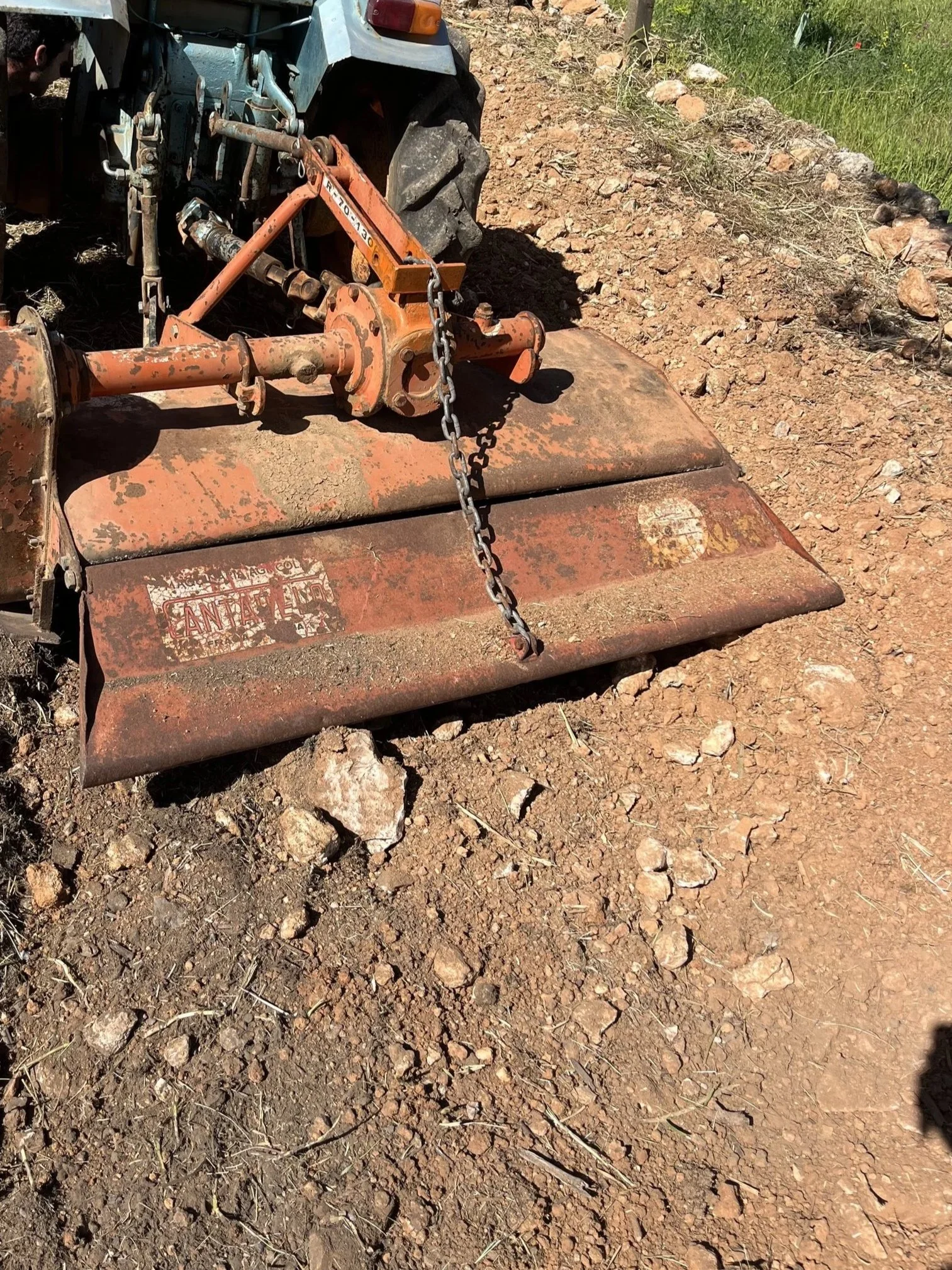 Tilling the soil with a tractor equipped with a rotavator to improve soil conditions and structure in San Rafael, Ibiza.